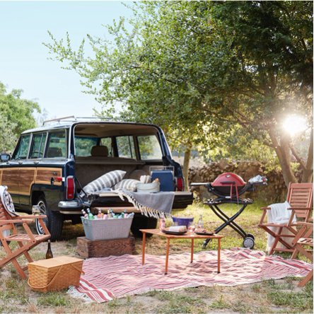 A vintage-style Volkswagon with a tailgating set up including stylish folding chairs, portable grills, and cozy outdoor decor form dxdailystore.com