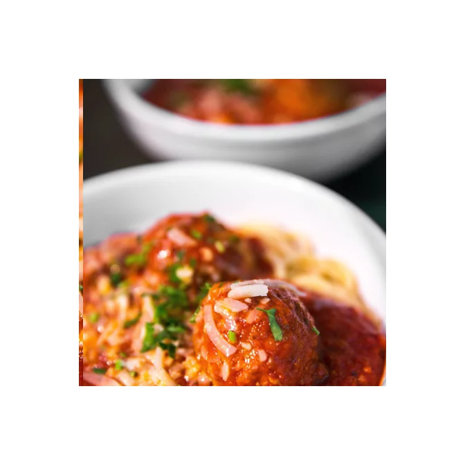 Seasoned meatballs in a small ceramic dish, ready to be served as an appetizer. 